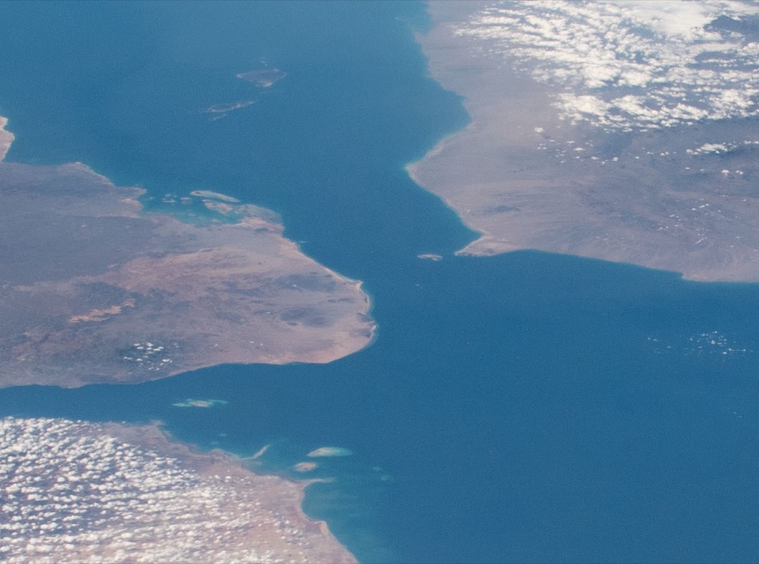 The Bab el-Mandeb strait between Yemen and Djibouti photographed from space, the southern gate to the Red Sea that India's exports to Europe must pass