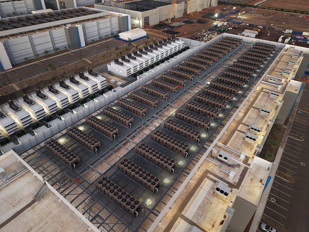 Cooling towers and backup generators on the roof of a data centre