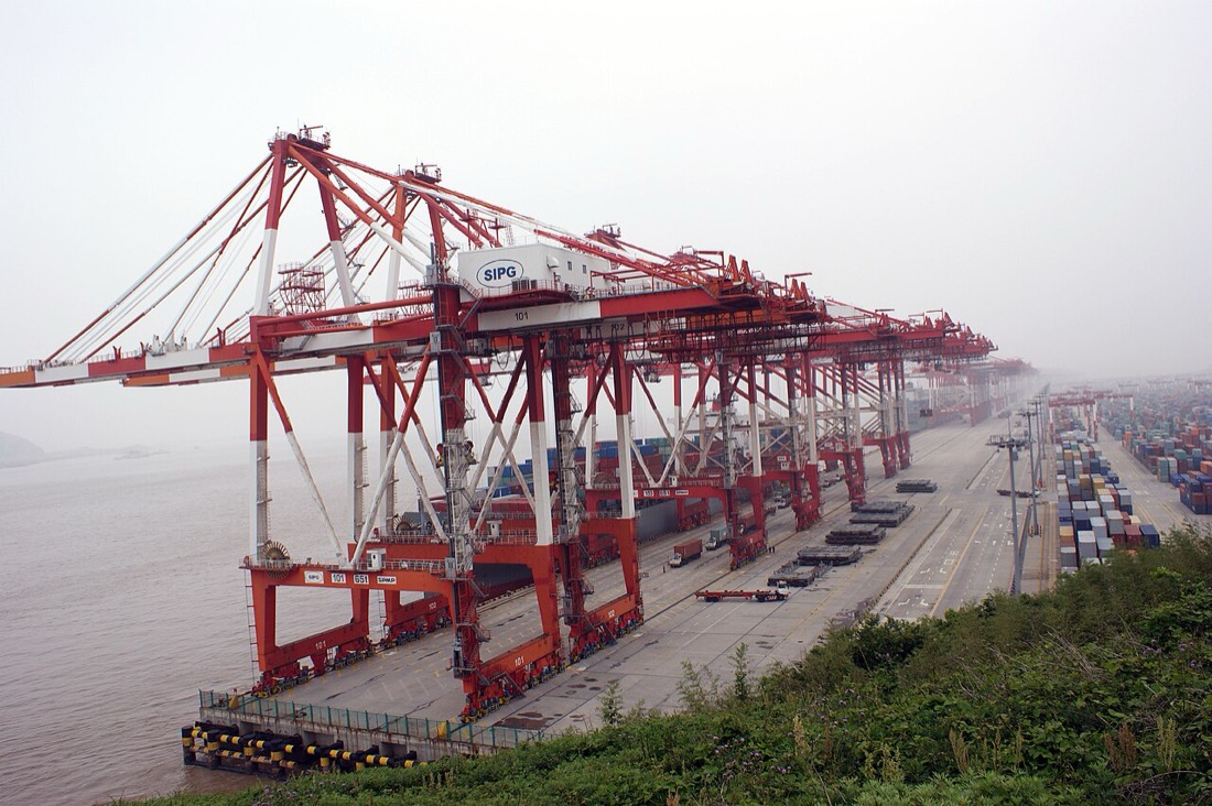 Container stacks at Yangshan port in Shanghai, the export machine behind China's record 2026 trade surplus