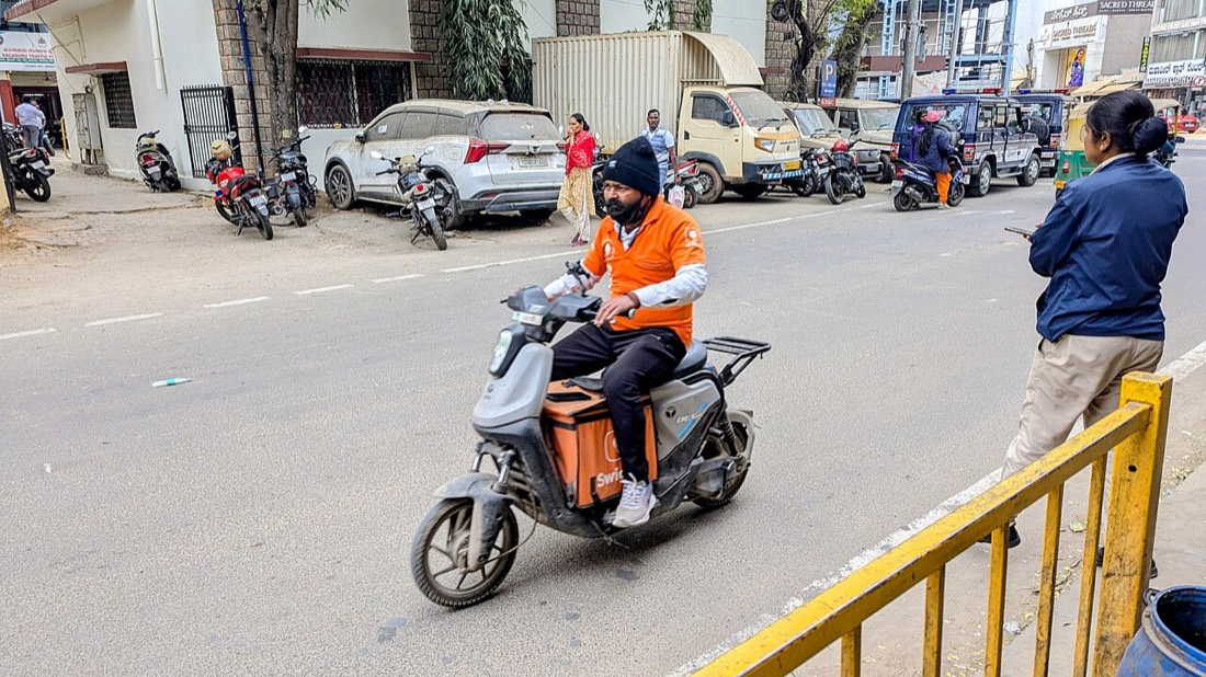 A Swiggy delivery partner on a scooter in Bengaluru