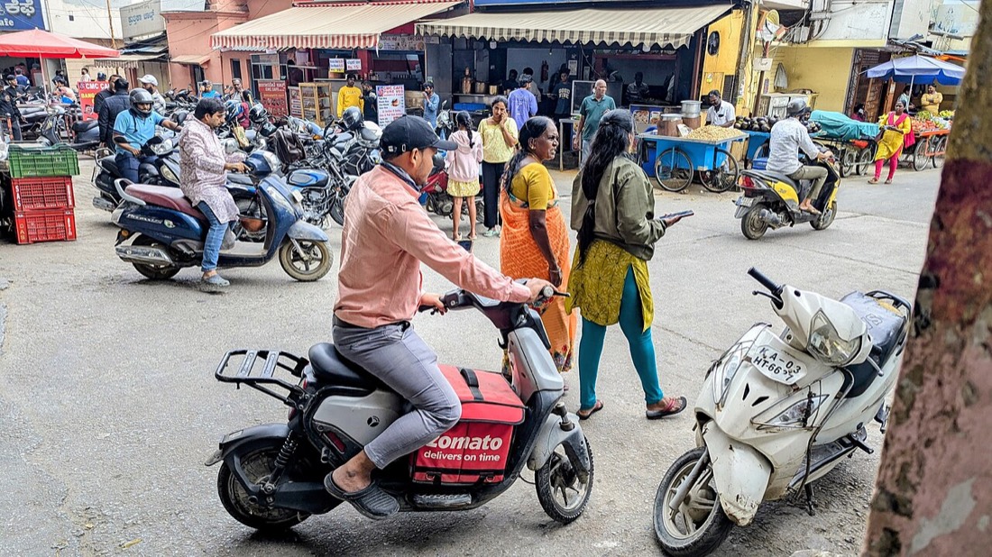 A Zomato delivery partner on a Yulu electric bike in Bengaluru, the food delivery business behind Eternal's roughly 749x price-to-earnings ratio